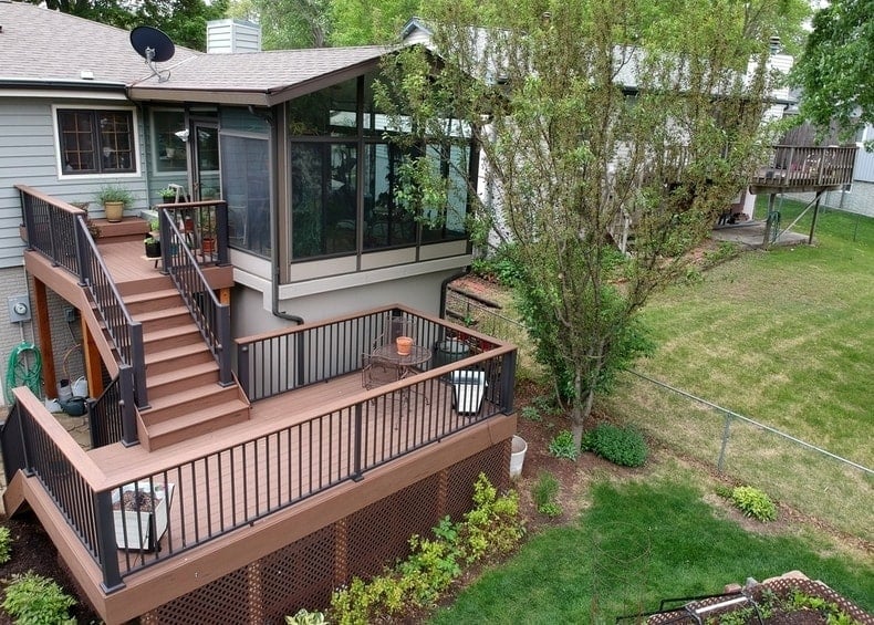 backyard composite deck and stairs leading into home sunroom