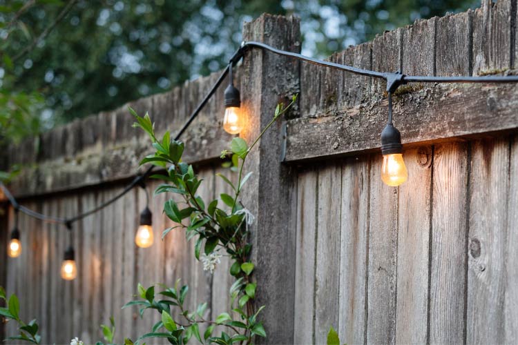 a non tacky way to brighten up your farmhouse landscape to emphasize its beauty after dark