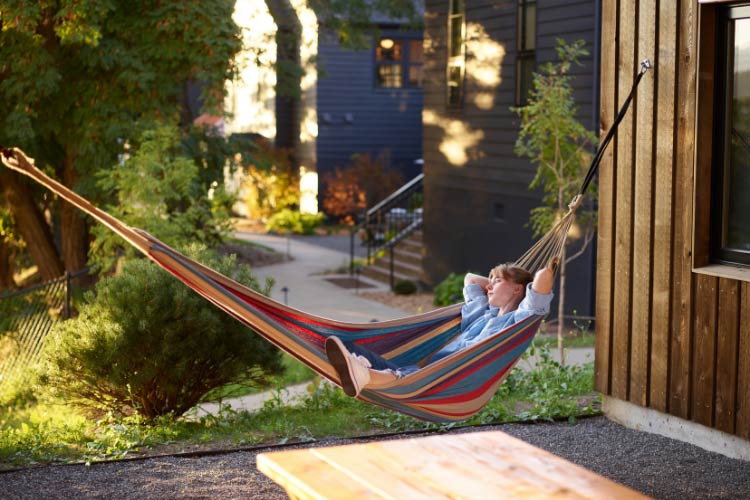 Hang it between sturdy trees or make a stand from wood or metal