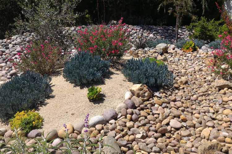 A dry creek bed is the perfect solution if your yard struggles with draining