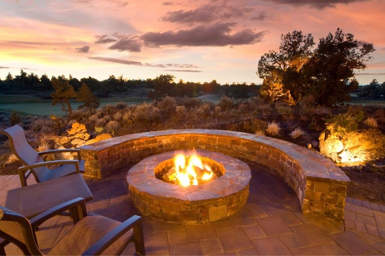 a fire pit can transform your sloped yard into a retreat with ambiance and function