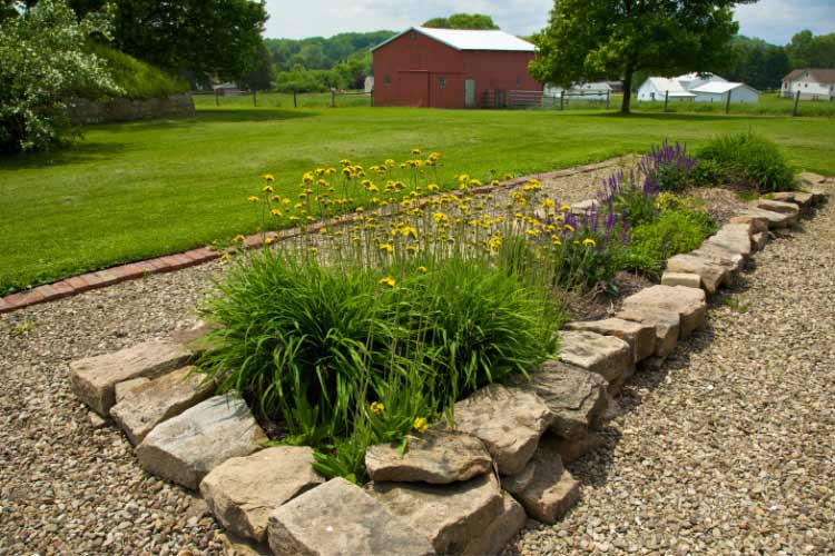 Enhance your outdoor space with pebble or river rock borders because cheap tropical backyard landscaping ideas