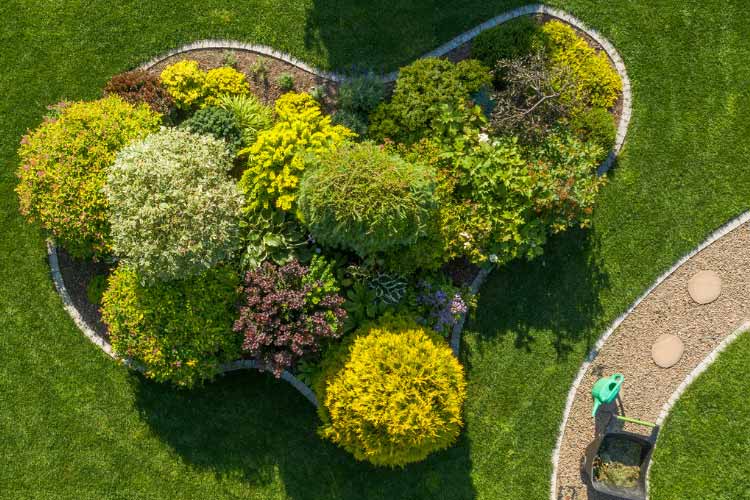 A raised island garden adds height and dimension to your landscape