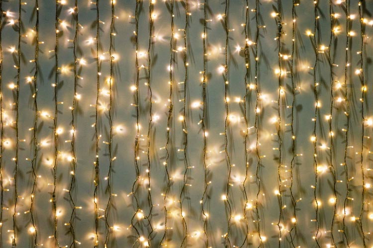 The cascading strands of LED bulbs that hang vertically resemble a waterfall of light