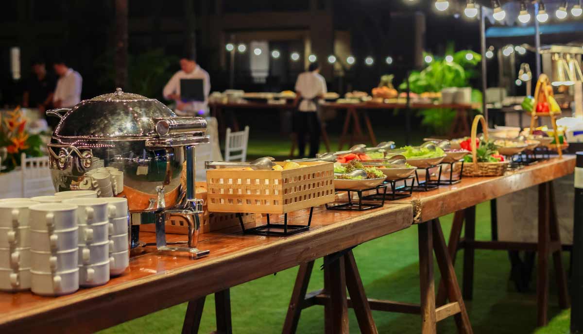 A buffet table is the perfect backyard party setup idea to keep food organized and guests moving