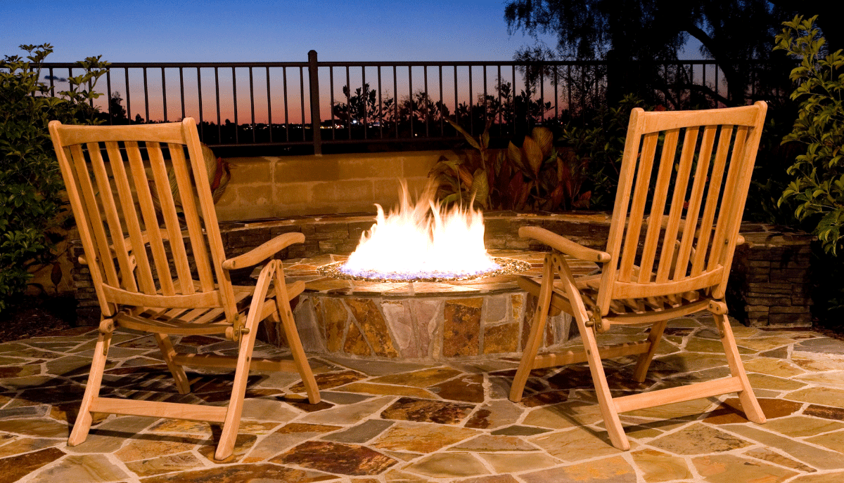 The beauty of rustic flagstone is that it makes your fire pit feel carved from the landscape rather than placed on it