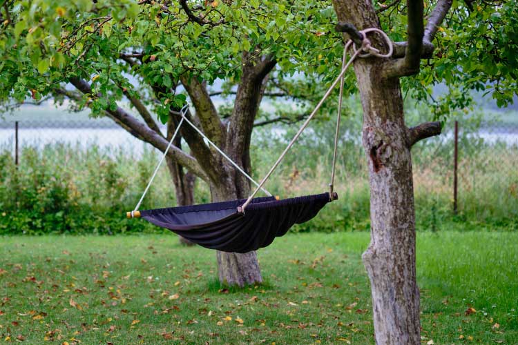 A hammock between trees is the stretched out equivalent of a hanging hammock chair