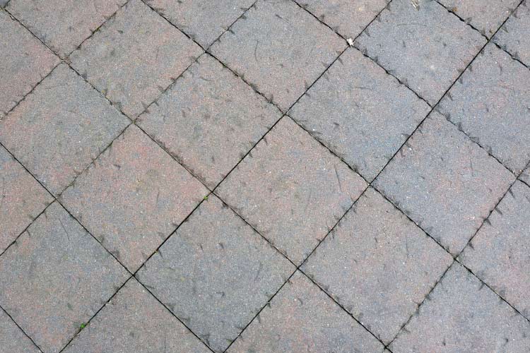 Lay these pavers in a grid or spaced pattern over compacted soil or sand