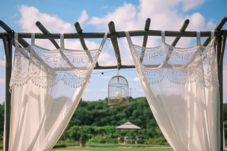 Not only do outdoor curtains on frames turn your backyard into a cozy retreat that looks good, but they also block light