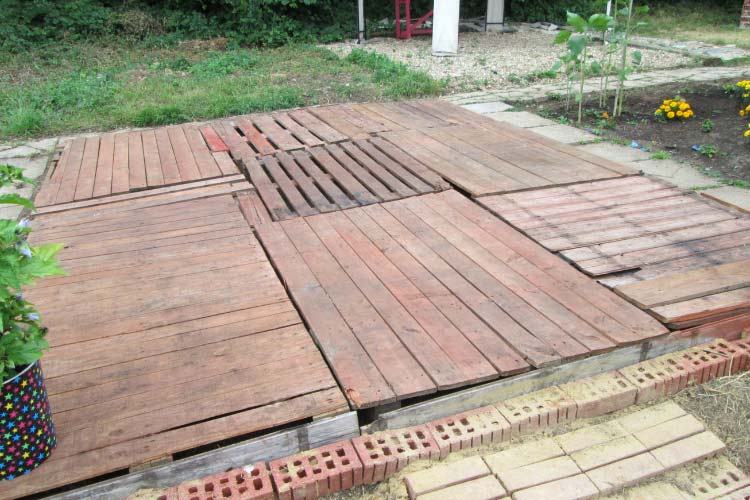 Lay a couple of pallets tightly together on level ground to create a raised surface for your party