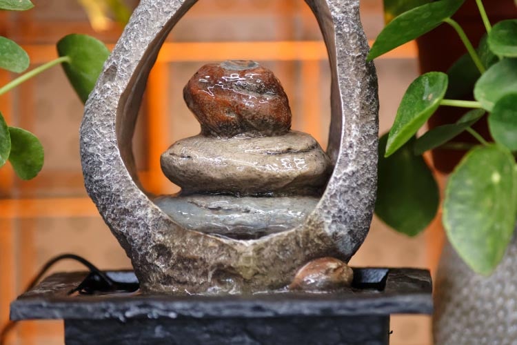 a portable water feature adds life to your backyard without the need for structural changes