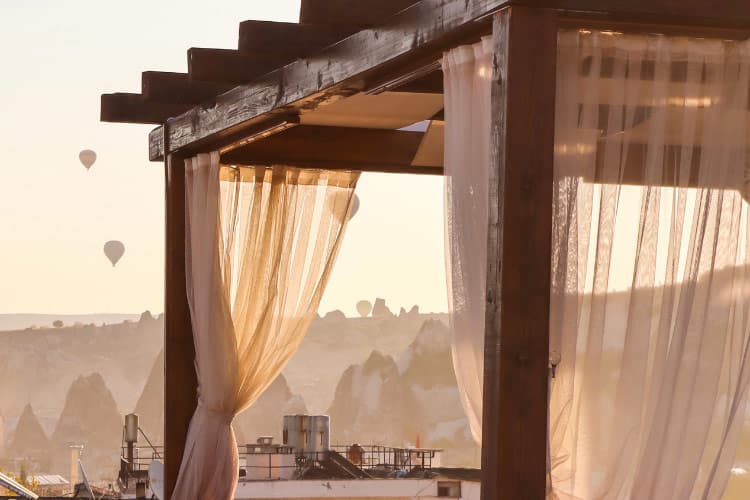 With a curtained pergola, you get the strength and the soft look