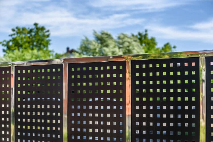 Using metal panels as a dog fence is going to require a bit more than materials and ideas