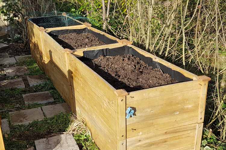 Build some rectangular boxes from pallet wood or rot resistant lumber and stack them as high as you need them to be to keep your doggos