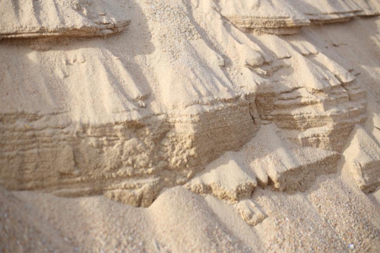 Not only does the sand fill the gaps between the stones to create a softer walking surface