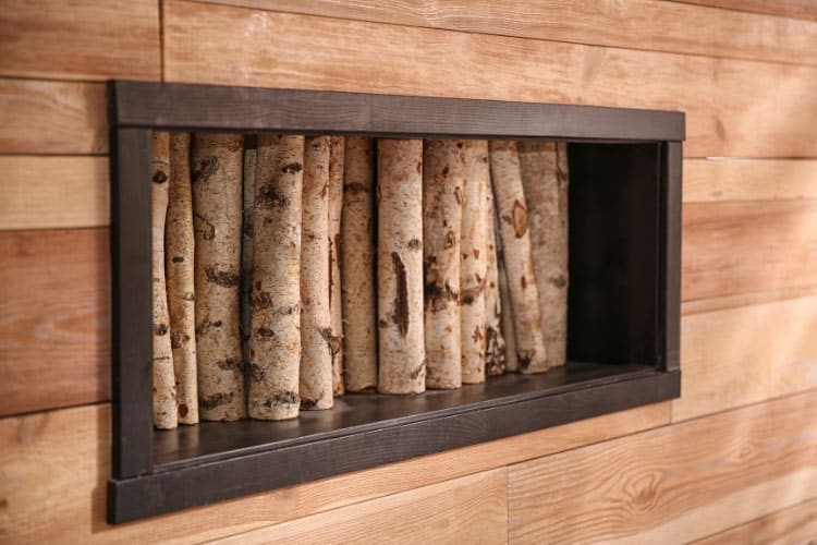 Firewood storage really can be as simple as a long shelf mounted on a wall